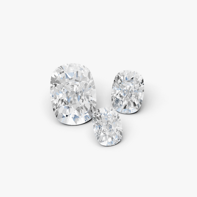 three cushion cut diamonds on a gray background