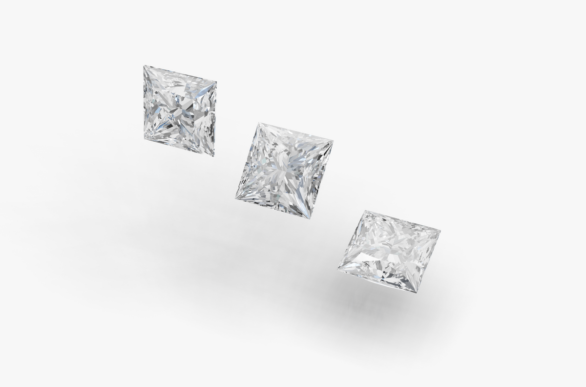 Three Princess cut diamonds on a gray background