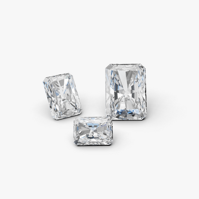 three radiant cut diamonds on a gray background