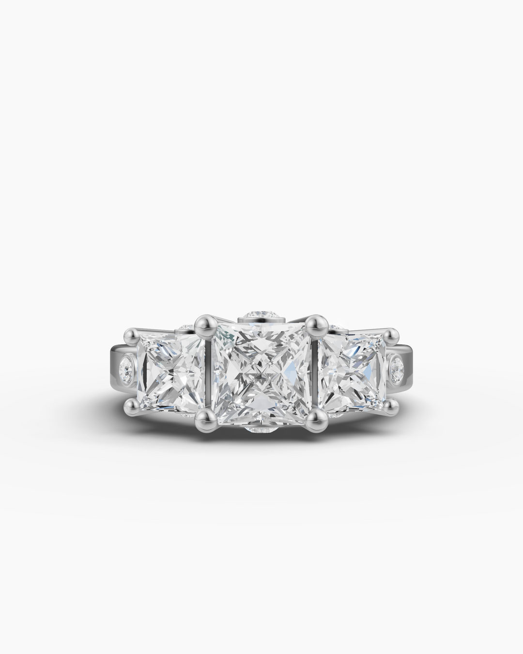 Gold ring with three square-cut diamonds on a white background