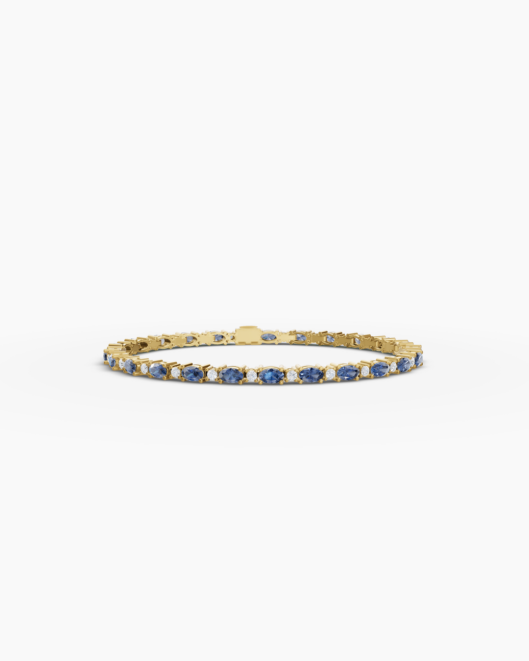 Gold bracelet with blue stones on a white background