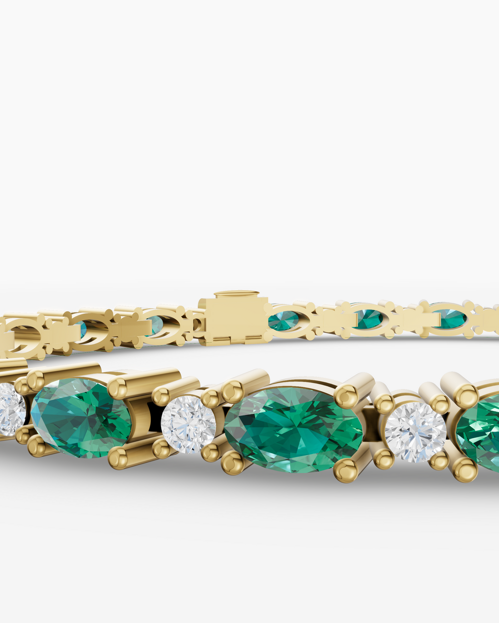Gold bracelet with emerald and diamond stones on a white background