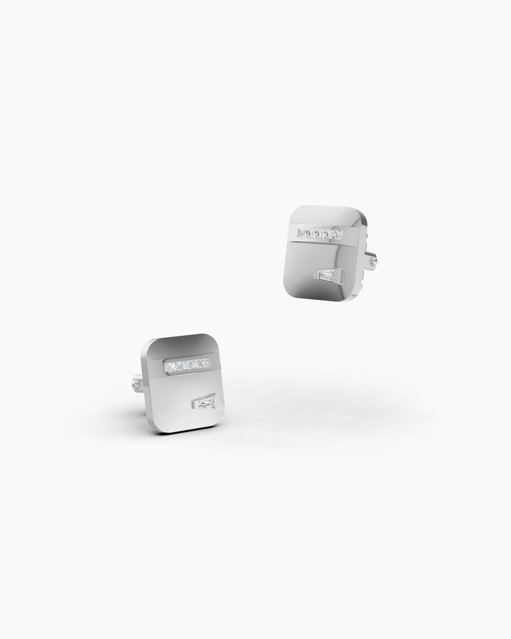 Two silver cufflinks with gemstones on a white background