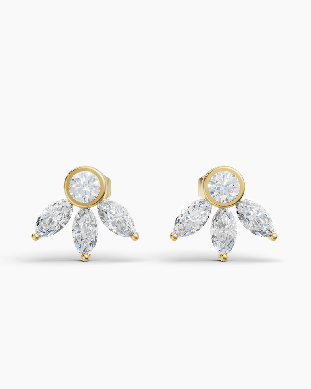 Gold earrings with clear gemstones on a white background