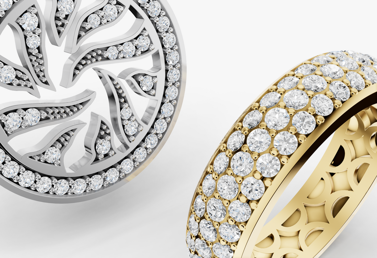 a diamond-encrusted ring and pendant, one white gold and one yellow gold, on a gray background.