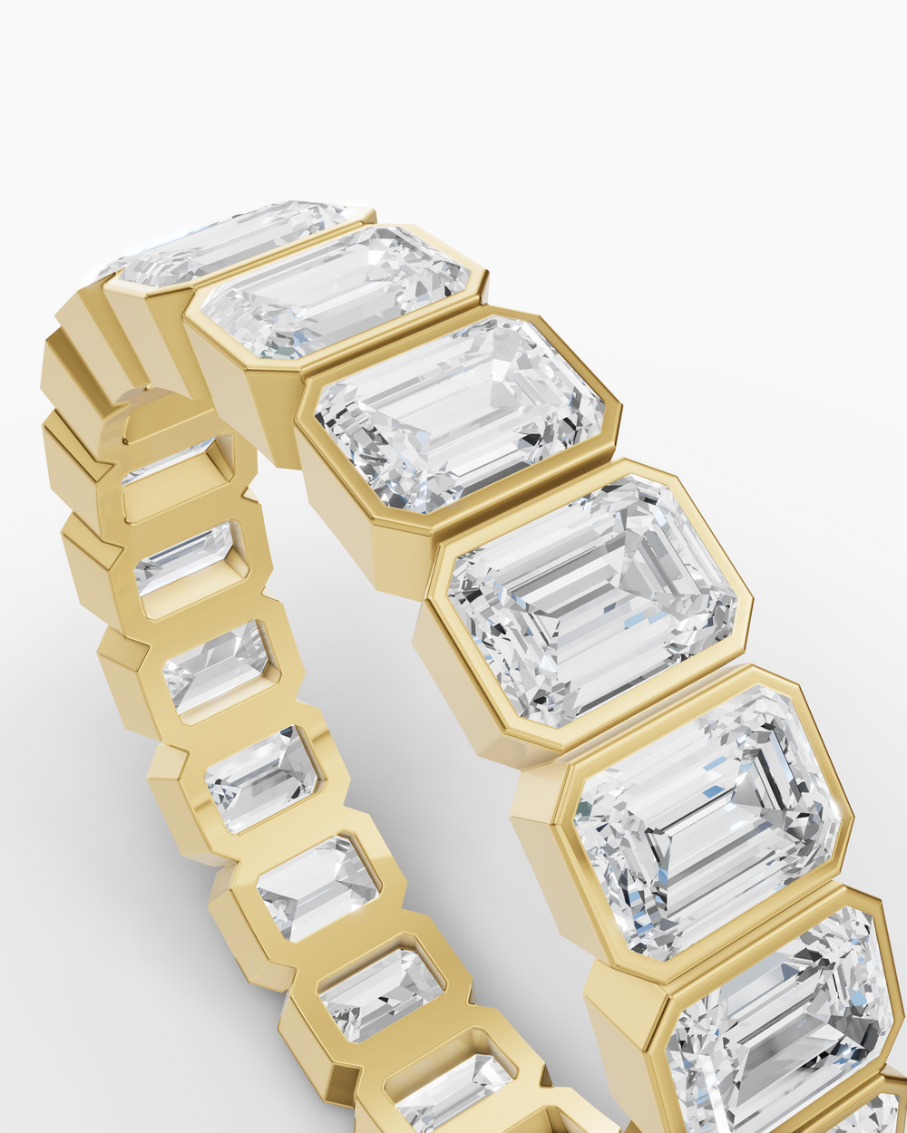 Gold ring with emerald-cut diamonds on a white background