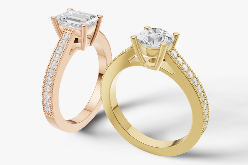Two diamond rings, one rose gold and one yellow gold, on a white background.